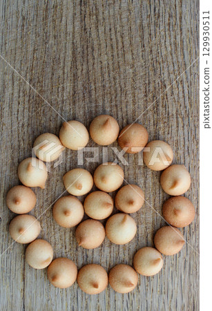 Homemade Mini Milk Cookies Laid Out In A Round Pattern On A Bakery Board Vertical Stock Photo Homemade Mini Milk Cookies Laid Out In A Round Pattern On A Bakery Board Vertical Stock Photo 129930511