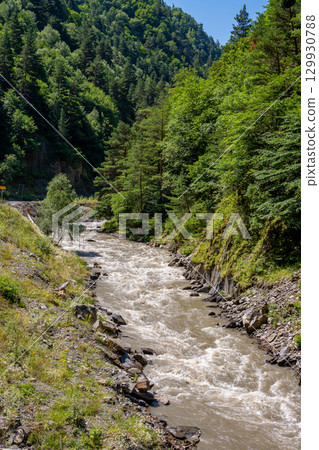 The beautiful valley of a mountain river in Khevsureti, Georgia. The beautiful valley of a mountain river in Khevsureti, Georgia. 129930788