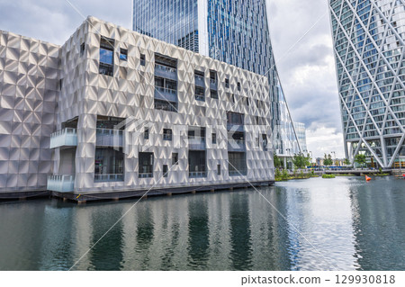 Modern Waterfront Architecture with Geometric Facade and Glass Towers Modern Waterfront Architecture with Geometric Facade and Glass Towers 129930818