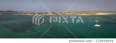 Drone view of the city of Sal Rei and two luxury yacht moored in turquoise ocean 129930958