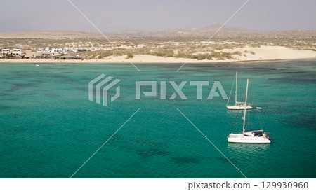 Aerial view of the luxury yacht moored in turquoise ocean background the desert 129930960