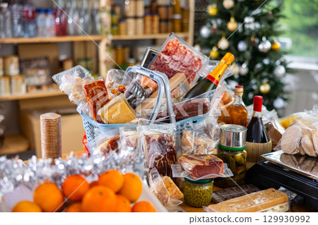Assortment of goods on counter, basket with products on table near scale, New Year Eve Assortment of goods on counter, basket with products on table near scale, New Year Eve 129930992