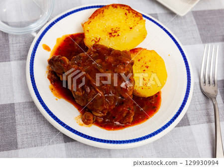 Fried pork cheek served on dish with potatoes Fried pork cheek served on dish with potatoes 129930994