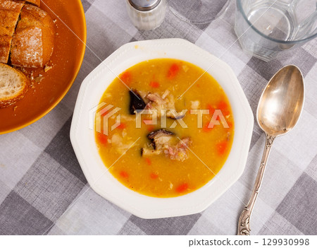 Hot pea soup with smoked meats and vegetables Hot pea soup with smoked meats and vegetables 129930998
