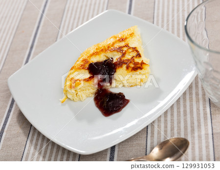 Cottage cheese casserole served with jam 129931053