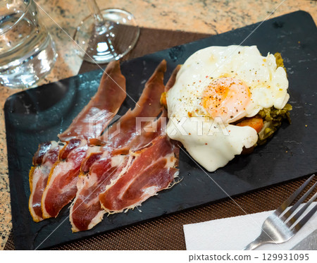 Fried egg with vegetables and ham Fried egg with vegetables and ham 129931095