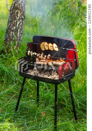 Mobile barbecue on the forest river bank. Mobile barbecue on the forest river bank. 129931190