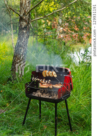 Mobile barbecue on the forest river bank. Mobile barbecue on the forest river bank. 129931191