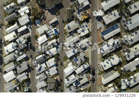 Destroyed by strong hurricane winds suburban houses in Florida mobile home residential area. Consequences of natural disaster 129931226