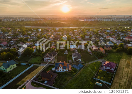 Aerial view of residential houses in suburban rural area at sunset 129931271