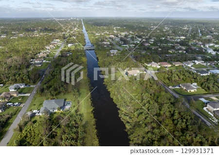 Consequences of natural disaster. Heavy flood with high water surrounding residential houses after hurricane rainfall in Florida residential area 129931371