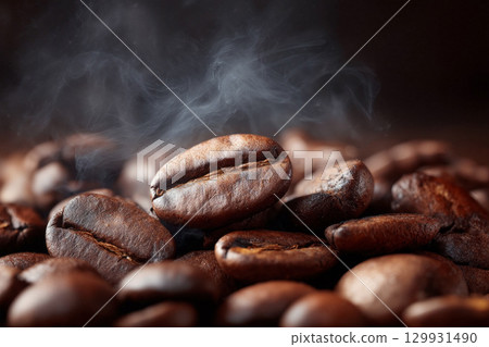 Rich coffee beans with steam rising in a warm atmosphere showcase fresh brewing process 129931490