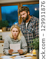 A Concerned Couple is Carefully Reviewing Important Financial Documents Within Their Home 129931876