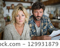 A Concerned Couple in Their Cozy Kitchen Engaged Deeply in Thought and Reflection 129931879