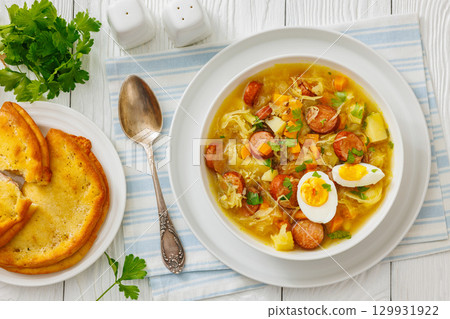 Polish sauerkraut soup with sausage in a bowl Polish sauerkraut soup with sausage in a bowl 129931922