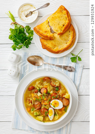 Polish sauerkraut soup with sausage in a bowl Polish sauerkraut soup with sausage in a bowl 129931924