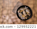 Fresh dorado fish prepared with lemon on a rustic table setting ready for serving 129932221