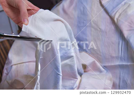 Woman cutting fabric ( side point of view close up) Woman cutting fabric ( side point of view close up) 129932470