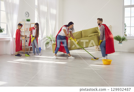 Superhero family mopping and sweeping floors while cleaning their house all together 129932487
