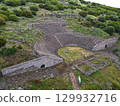 Aerial view of the ancient amphitheater ruins in Assos Turkey among hills 129932716
