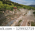 Roman columns and hillside ruins along the marble avenue in Ephesus, Turkey 129932719
