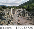 Stone arch on paved avenue among ruins of ephesus archaeological site, Turkey 129932720