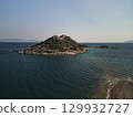 Aerial view of small islet with Turkish flag and sand spit, Aegean Turkey 129932727
