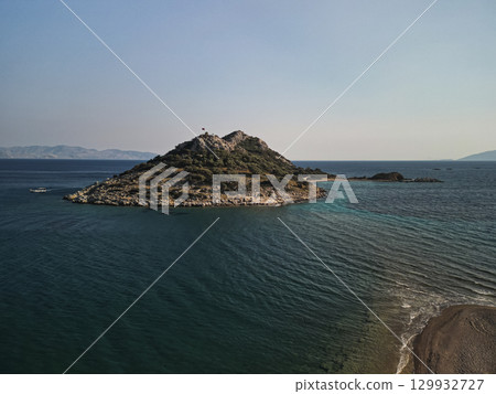 Aerial view of small islet with Turkish flag and sand spit, Aegean Turkey 129932727
