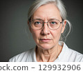Serious Portrait of a Middle-Aged Woman with Glasses 129932906