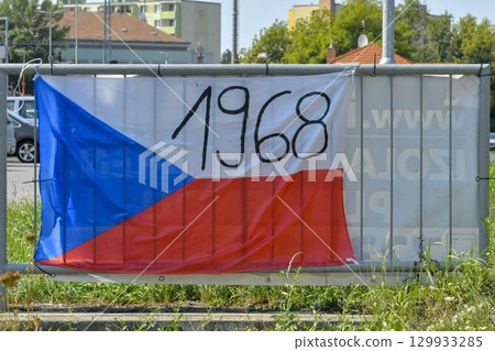 View of the Czech flag displayed on the railing. The flag shows the year 1968. On 20 21 August 1968, the Czechoslovak Socialist Republic was jointly invaded by four Warsaw Pact countries: the Soviet View of the Czech flag displayed on the railing. The flag shows the year 1968. On 20 21 August 1968, the Czechoslovak Socialist Republic was jointly invaded by four Warsaw Pact countries: the Soviet 129933285