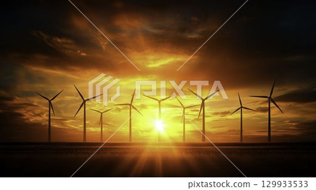 Wind Turbines Silhouetted Against a Vibrant Sunset Over a Calm Horizon Landscape 129933533