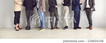 Legs of different business people standing in row and communicating with each other. Legs of different business people standing in row and communicating with each other. 129934148