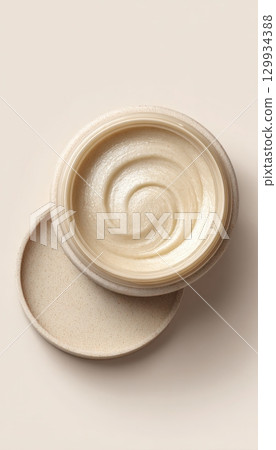 Studio Shot of Shea Butter Balm with Open Lid on Minimal White Background 129934388