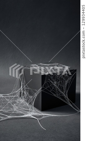 Minimalist Halloween Decor: White Cobwebs on Matte Black Cube 129934405