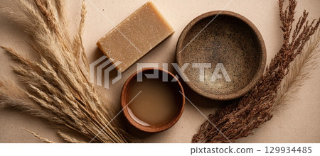 African Soap and Oil with Dry Grass on Kraft Paper Background 129934485