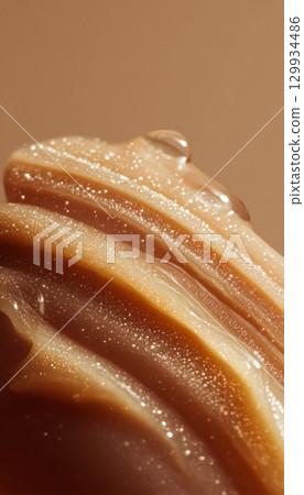Macro Shot of Balm Melting on Fingertips with Visible Skin Lines 129934486