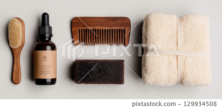 Natural Beard Oil, Wooden Comb, Towel, and Soap on White Background 129934508