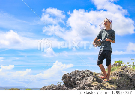 Okinawan islanders playing the sanshin on the beach Okinawan islanders playing the sanshin on the beach 129934737