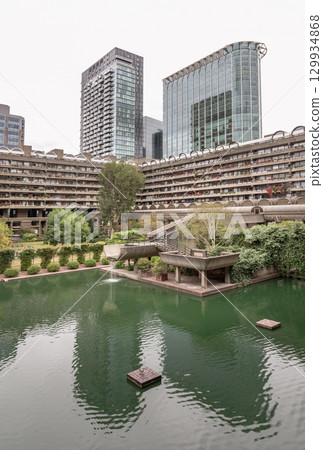 The Barbican Centre in London is renowned for its unique integration of multi-level water gardens and greenery within its Brutalist architectural design. 129934868