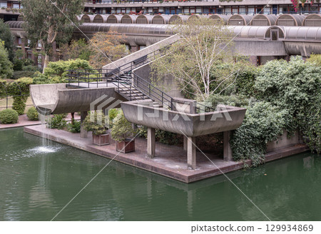 the Barbican Centre's unique multi-level water gardens, which seamlessly integrate concrete staircases and elevated planters within the landscape design, The plants and trees contribute to the 129934869