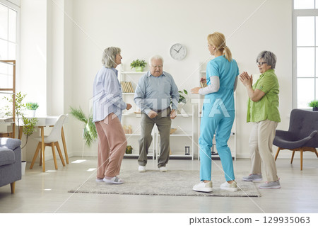 Happy Seniors Dancing With Doctor Or Nurse In Senior Home Happy Seniors Dancing With Doctor Or Nurse In Senior Home 129935063