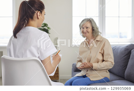 Senior people care, young kind nurse, geriatric medicine caretaker talking to old woman Senior people care, young kind nurse, geriatric medicine caretaker talking to old woman 129935069