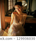 A stylish, beautiful Japanese woman relaxing by the window (square photo) 129936030