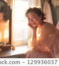 A stylish, beautiful Japanese woman relaxing by the window (square photo) 129936037
