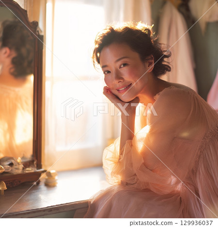 A stylish, beautiful Japanese woman relaxing by the window (square photo) 129936037