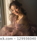 A stylish, beautiful Japanese woman relaxing by the window (square photo) 129936040