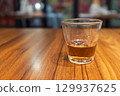 木質桌面上的一杯琥珀色飲料 129937625
