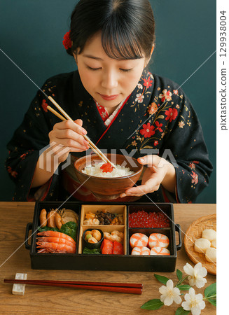 A woman eating New Year's dishes 129938004