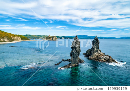 Stunning coastal landscape at sunrise with distinct rock formations and clear ocean waters 129939159