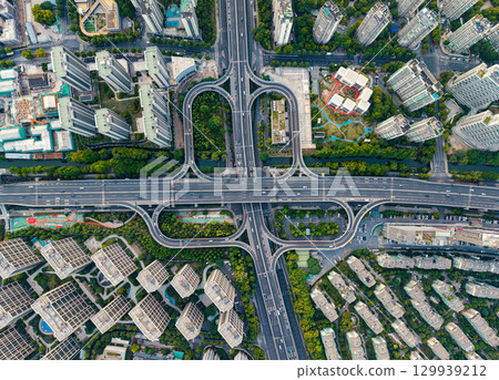 Aerial top down view of a busy junction reveals a multitude of vehicles traveling on various roadways. Hangzhou, China. Aerial top down view of a busy junction reveals a multitude of vehicles traveling on various roadways. Hangzhou, China. 129939212